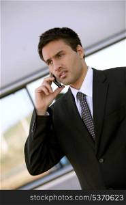 Concerned businessman holding cellphone