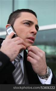 Concerned businessman on the phone to boss