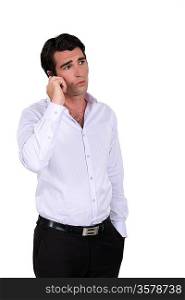 Concerned businessman taking phone call