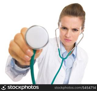 Concerned doctor woman listening with stethoscope