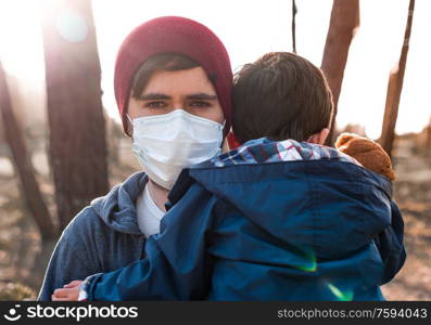 Concerned father and son using air protection masks