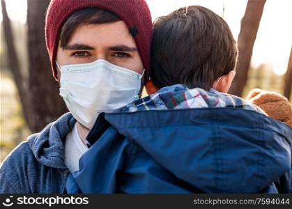 Concerned father and son using air protection masks
