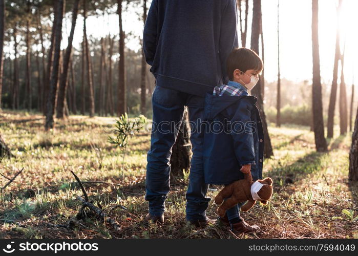 Concerned father and son using air protection masks