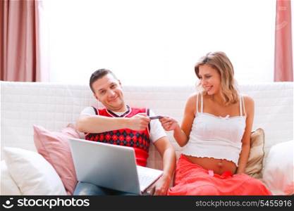 Concerned husband giving credit card to his pregnant wife&#xA;