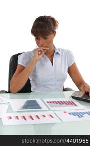 Concerned office worker working with bar charts