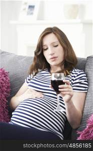 Concerned Pregnant Woman Drinking Red Wine