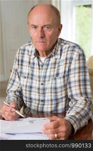 Concerned Senior Man Reviewing Domestic Finances