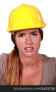 Concerned woman in a hardhat