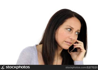 Concerned woman on mobile telephone