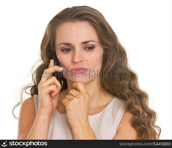 Concerned young woman talking cell phone