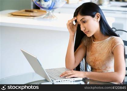 Concerned Young Woman Using Laptop