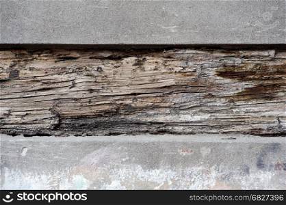 Concrete and wood. Backgrounds and textures: old wood plank between concrete blocks