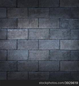 Concrete block wall or weathered cinderblock background with a blank rough rustic cement surface texture as a backdrop of an urban building detail with copy space.