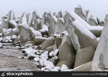 concrete breakwaters in winter, concrete coastal protection in snow. concrete coastal protection in snow, concrete breakwaters in winter