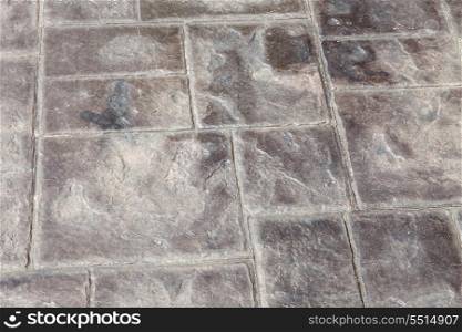 Concrete grey floor with symmetrical patterns