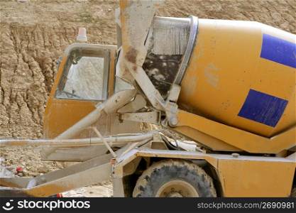 Concrete mixer truck detail in yellow with blue stripes