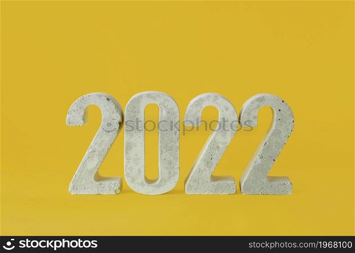 concrete numbers 2022 on a yellow background.