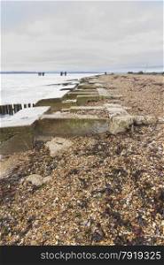 Concrete remains of phoenix breakwater caissons. Lepe Beach, Hampshire, England, United Kingdom.