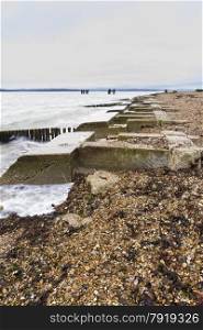 Concrete remains of phoenix breakwater caissons. Lepe Beach, Hampshire, England, United Kingdom.