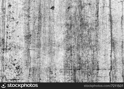 Concrete stain in the white wall, Texture of grey concrete wall with dark water marks running vertically down lines.