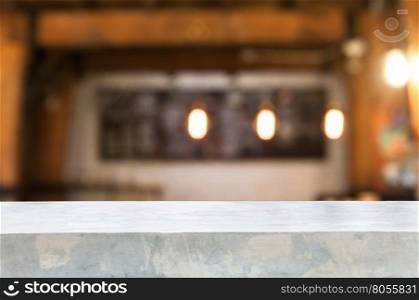 Concrete table top with coffee shop blurred abstract background
