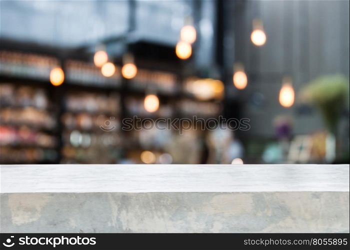 Concrete table top with coffee shop blurred background with bokeh