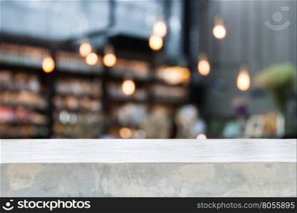 Concrete table top with coffee shop blurred background with bokeh