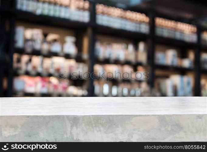 Concrete tabletop with coffee shop blurred background with bokeh