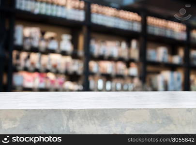 Concrete tabletop with coffee shop blurred background with bokeh