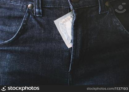 Condom man ready to use in pocket Jeans zipper pants, give condom safe sex concept on the bed Prevent infection and Contraceptives control the birth rate or safe prophylactic. World AIDS Day,