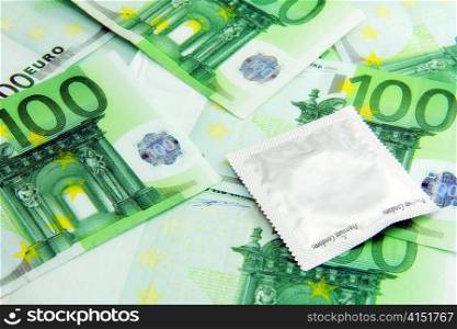 Condom on Euro paper money for safe sex