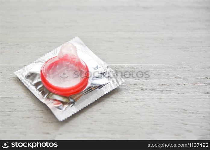Condom Prevent Pregnancy Contraception Valentines safe sex concept / Birth Control with Condom on white wood background - pregnancy or sexually transmitted disease