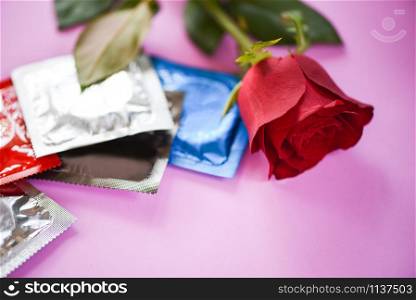 Condom Prevent Pregnancy Contraception Valentines safe sex concept / Birth Control with Condom and roses flower love on pink background - pregnancy or sexually transmitted disease