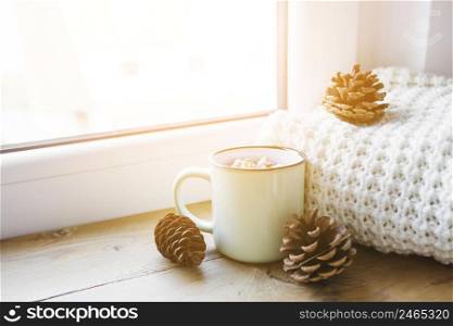 cones hot chocolate near scarf window