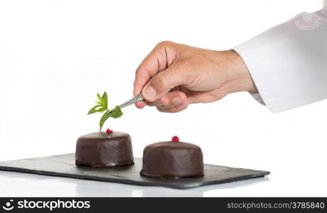 Confectioner putting the last ornament to a cake