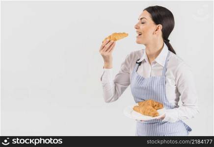 confectioner woman tasting croissant