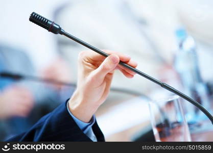 Conference hall with microphones. before a conference, the microphones in front of empty chairs.