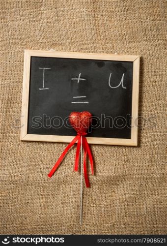 Confession of love on black chalkboard against linen cloth
