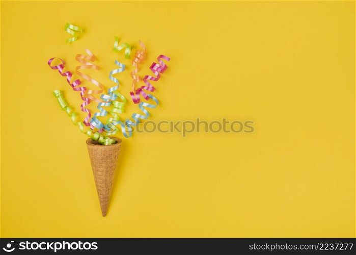 confetti ice cream cone with copy space yellow background