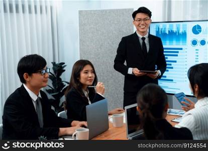 Confidence and asian businessman give presentation on financial analyzed by business intelligence in dashboard report to other people in board room meeting to promote harmony in workplace.. Confidence and young asian businessman give presentation to promote harmony.