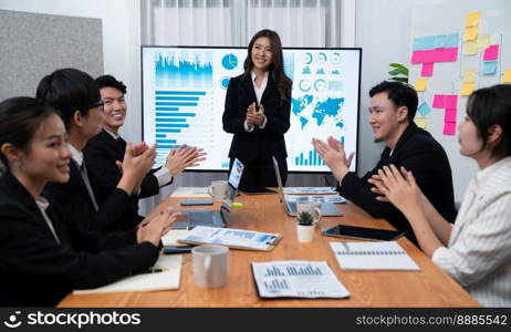 Confidence and young asian businesswoman give presentation on financial business strategy in dashboard report display on screen to colleagues in conference room meeting as harmony in workplace concept. Businesswoman give presentation on dashboard data on screen at harmony office.