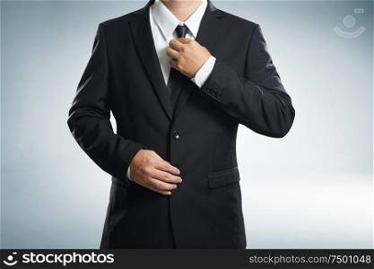 Confidence businessman in black suit , close up .