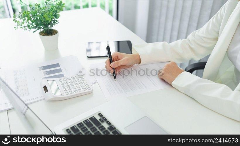 Confidence woman concept, Businesswoman analyzing strategy of business and writing data on document. 