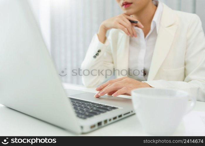 Confidence woman concept, Businesswoman is thinking strategy of business and typing data on laptop.