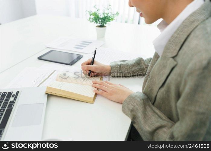 Confidence woman concept, Businesswoman taking note information on notebook while video conference.
