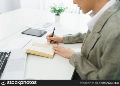 Confidence woman concept, Businesswoman taking note information on notebook while video conference.