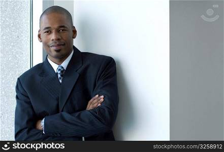 Confident African-american business man with arms folded.