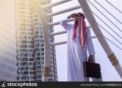 Confident Arabian Businessman standing and looking at city background for vision concept
