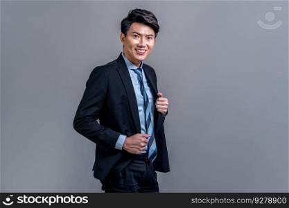 Confident Asian bossy businessman posing in professional formal black suit-clad on isolated background. Success corporate office worker for business promotion and advertisement. Jubilant. Confident Asian businessman posing on isolated background. Jubilant