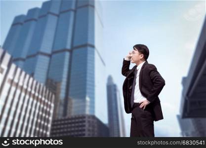 Confident Asian Businessman standing and looking at city for vision concept